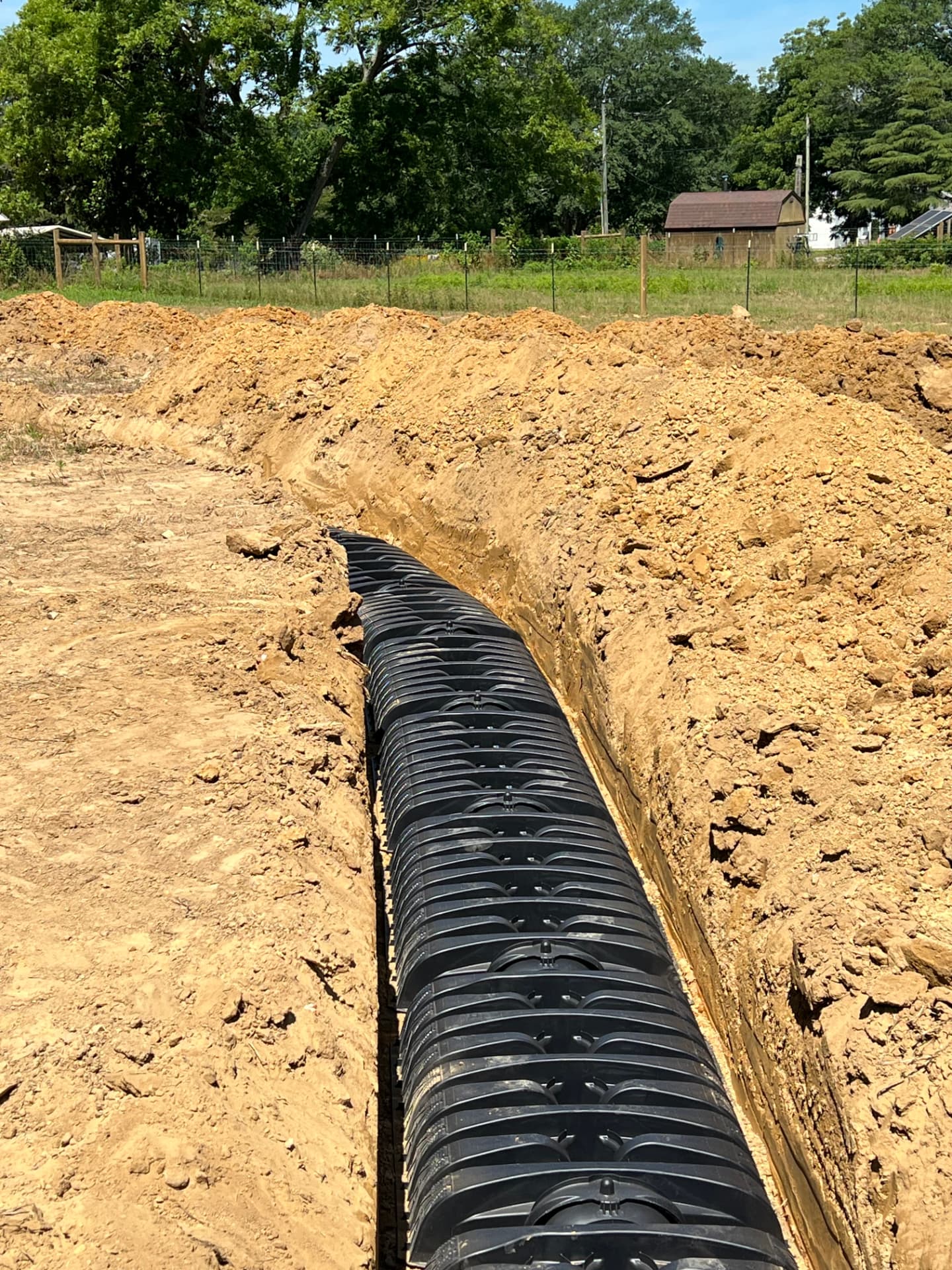 Septic leach field chamber install in a freshly dug trench near Gadsden, Alabama